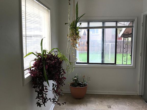 Sunroom off of kitchen has newer laminate flooring.