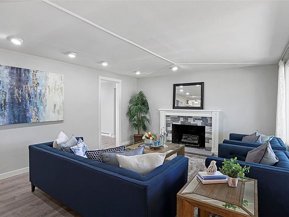 The living room features lots of recessed lighting and a brand new fireplace surround and mantel! 