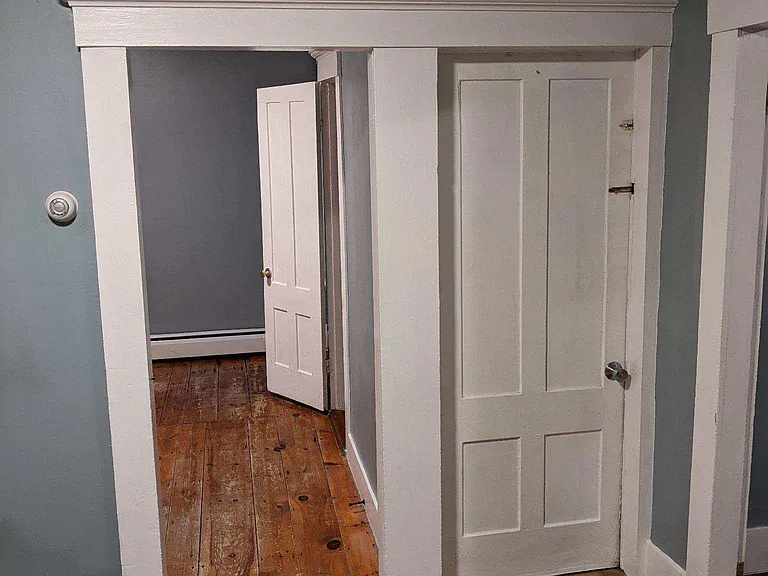 From the living room looking to entry of bedroom 2