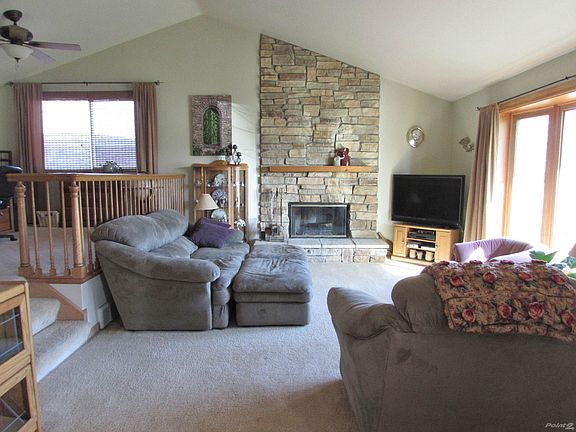 Living Room: Beautiful living room with vaulted ceiling and stone fireplace.