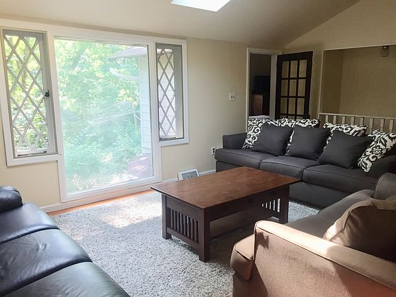 Living room with skylights offers plenty of seating