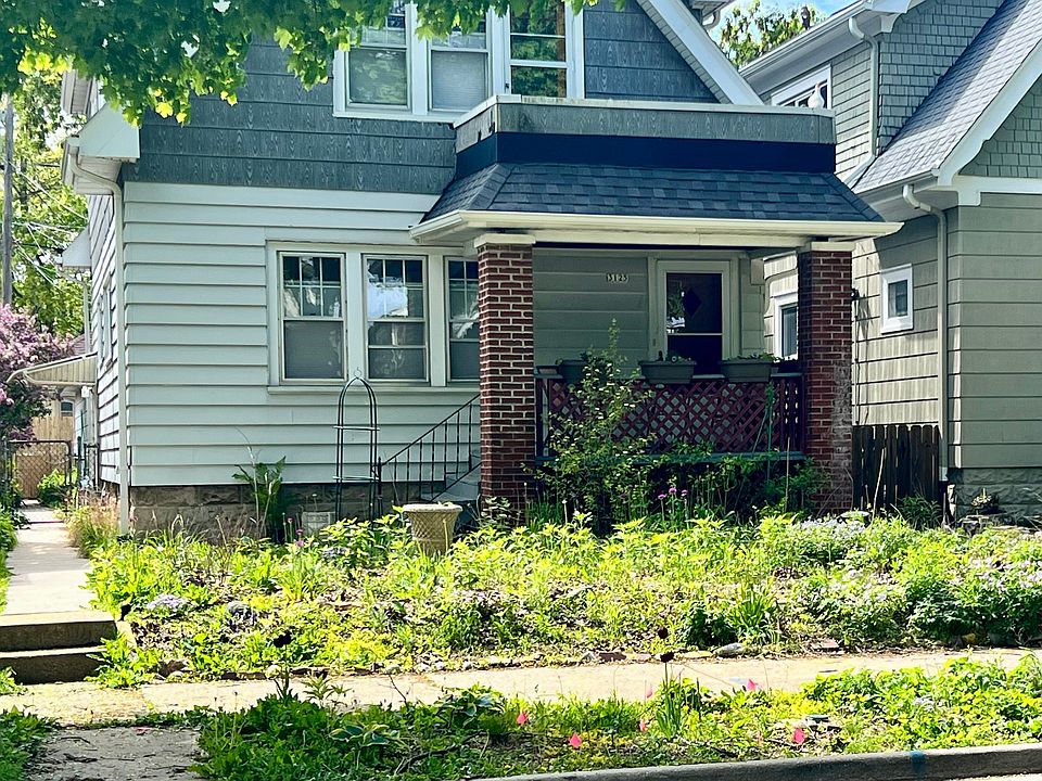 Exterior. Rain garden, with local native pollinator plants. Entrance to upper unit is via back door. Upper unit deck above front porch. House has native Wisconsin pollinator front yard (with a few ornamentals) that is on the Riverwest Secret Garden Tour.