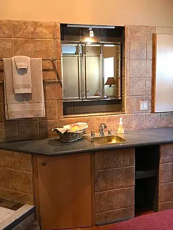 Additional personal brass sink in master bedroom.