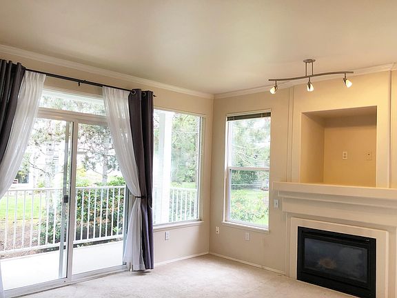 Living room w/ Gas fireplace, lots of light, balcony