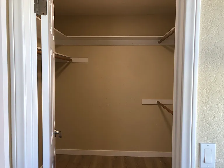 Walk in closet in primary bedroom