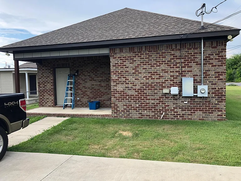 Rear entry to home. Security system keypad located at back door. LED flood lights on all corners of home. Concrete parking area with 3 dedicated parking spaces.