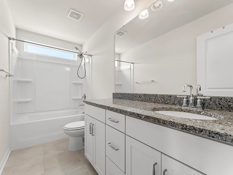 upstairs guest bathroom with ample countertop space