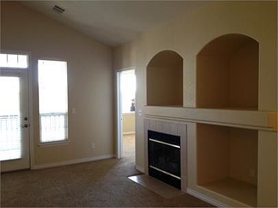 Gas fireplace with patio doors leading to deck from living r