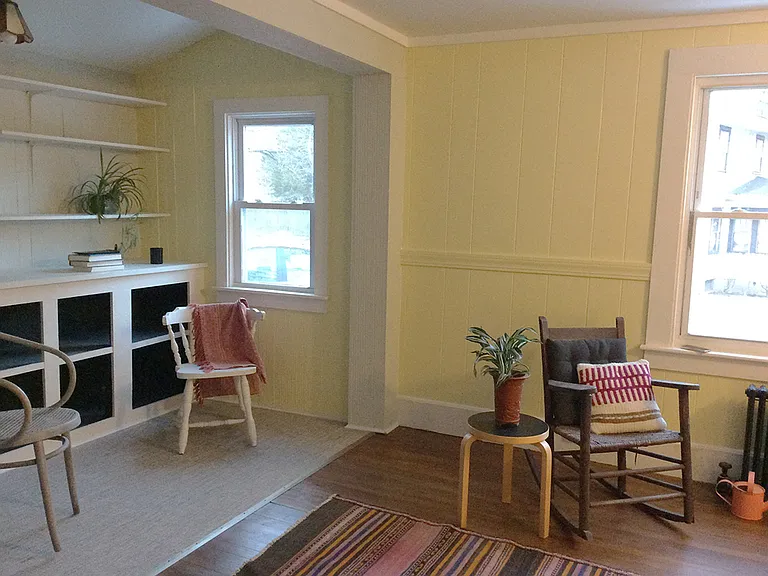 Built-in storage for books and media off living area. Hardwood floors and linoleum tiles.