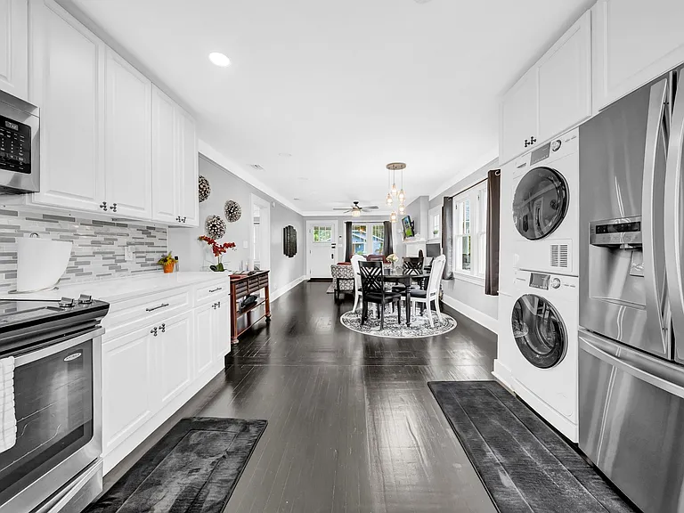 Kitchen includes stainless steel appliances, and washer and dryer