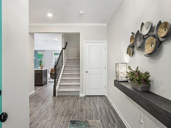 Foyer leads to main living space Photo is a representation of home.