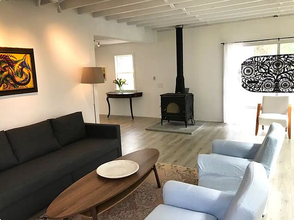 Living room with wood burning fireplace.