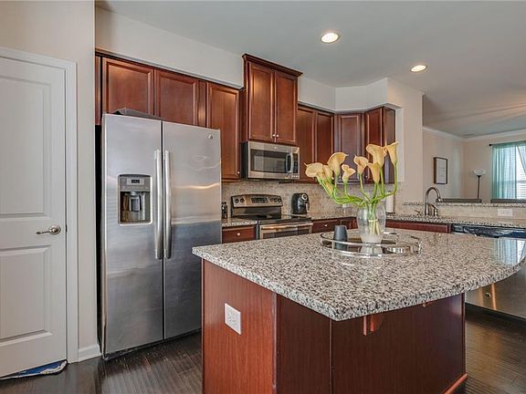 Granite counters. Upgraded cabinets & opt backsplash. Center island.