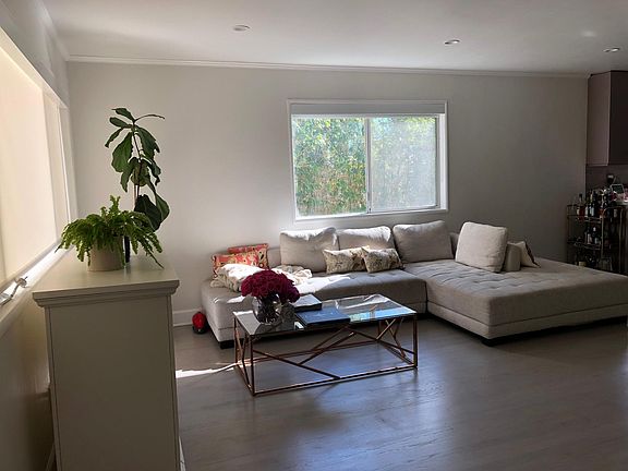 Total privacy in the living room. The norther exposure has a privacy screen that still lets light through and the eastern exposure is faces the pool, a border of bamboo trees and a cottage on the other side.