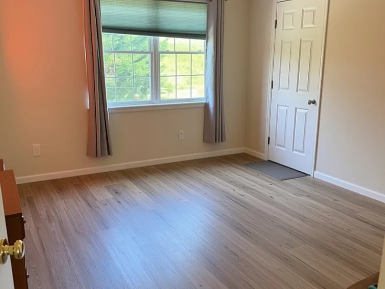 Upstairs back bedroom-this is AI edited to show more simple concept and remove personal articles. Door is to walk in closet. 12'x13'6"