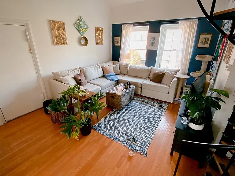 Open living room features large windows and cathedral ceiling