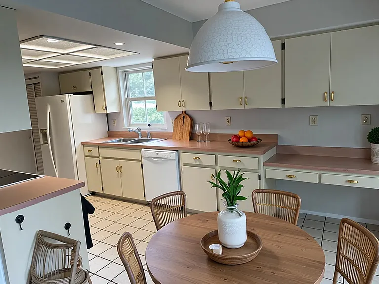 Eat-in kitchen with sliders opening to screened patio.