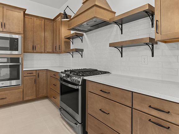 Kitchen with stylish floating shelves