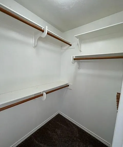 Master walk in closet His and Hers, both same size on either side of bathroom