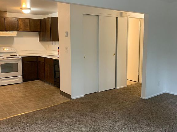 view from front corner of living room looking toward kitchen and down hall