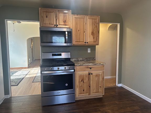 Kitchen with microwave and gas range with convection oven