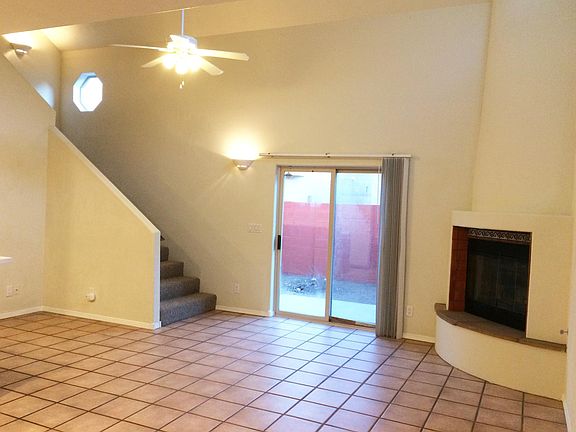 Living room, fireplace, door to backyard and staircase