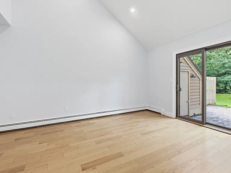 Den with sliding glass doors to backyard