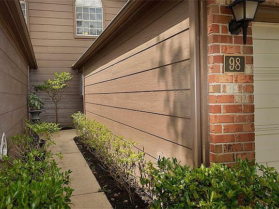 Inviting entryway lined with shrubs.