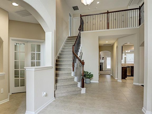Elegant staircase compliments the inviting foyer as you enter the home.