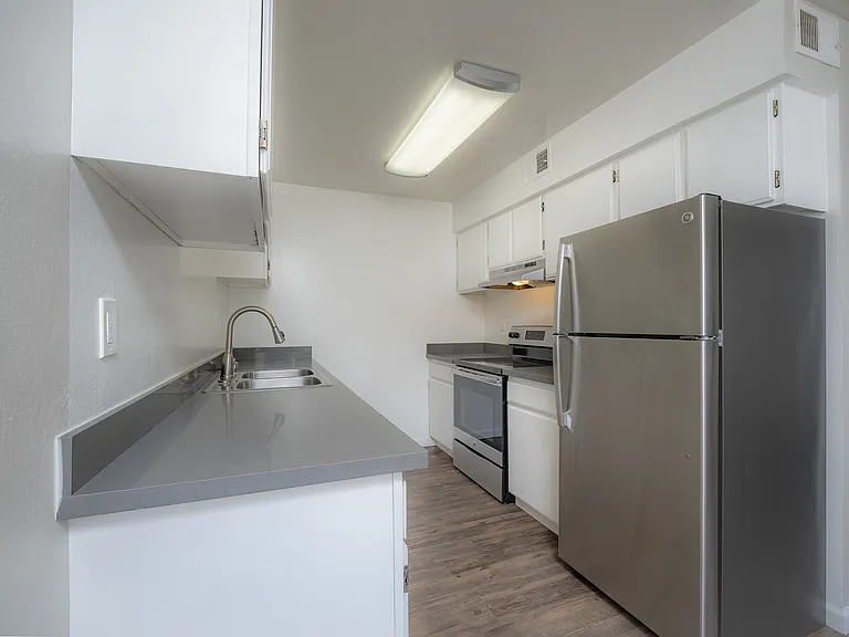 Step into this sleek kitchen, designed with modern style and efficient functionality.