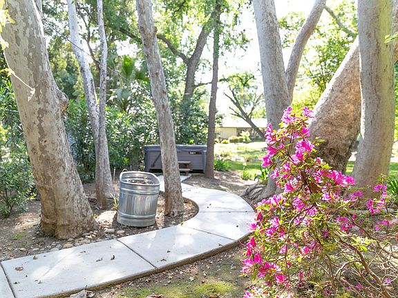 Path to hot tub, lit with string lights.