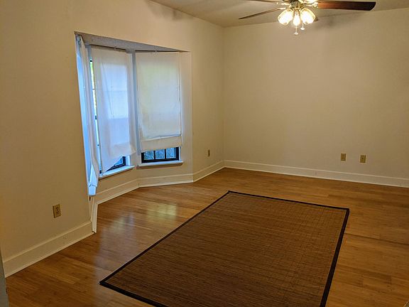 Living room with bay window and bamboo floors.