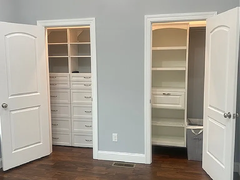 Double deep closets with custom cabinets.