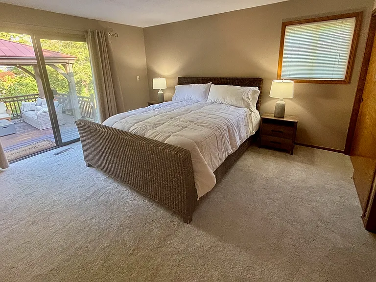 Light and bright primary bedroom with ensuite bathroom. California King bed and 55" wall mounted TV.