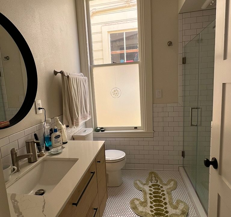 Bathroom with vanity, walk-in waterfall shower, washer / dryer, and lots of elevated storage, Moen faucets