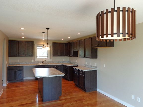 The kitchen also has hardwood flooring.