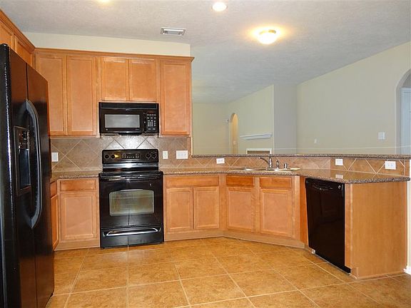 Beautiful wood cabinets and silestone countertops, ready for your food prep.
