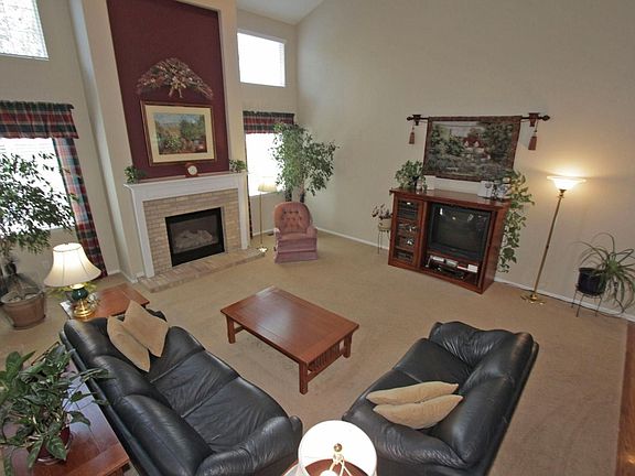 Fmaily room is surrounded by hardwood flooring