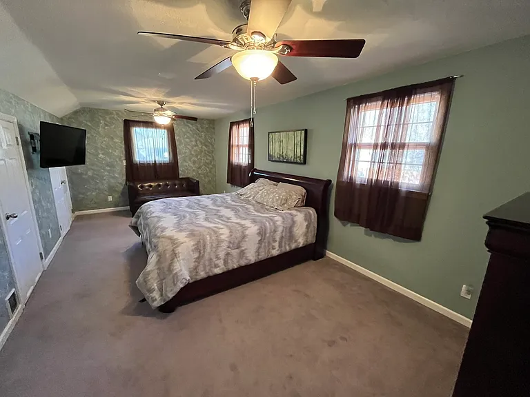 Double Dormer Room - that is a California King Bed - Brand NEW Mattress and $300 cover - Never Used. And the bed raises at the head! 3 large closets, Small leather room sofa, 2 NEW ceiling fans/lights and Chest of Drawers that matches the Bed frame.