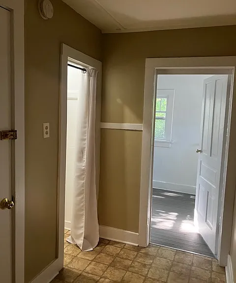 rear hall to sunroom with coat closet