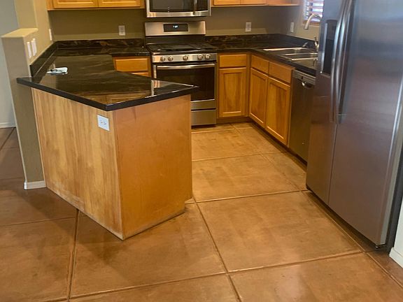 Open Kitchen with recent Stainless Steel Appliances