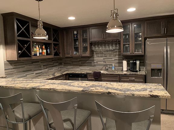 Basement Bar with stainless steel appliances and wine chiller.