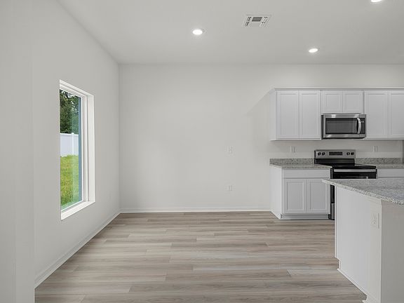 The dining room has a window overlooking that back yard