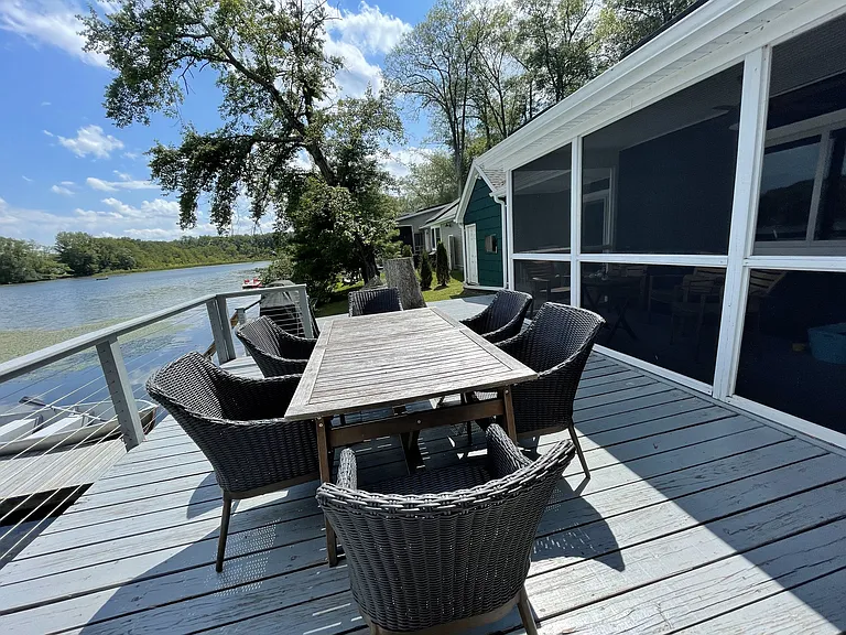 Dining table on back deck overlooking the lake