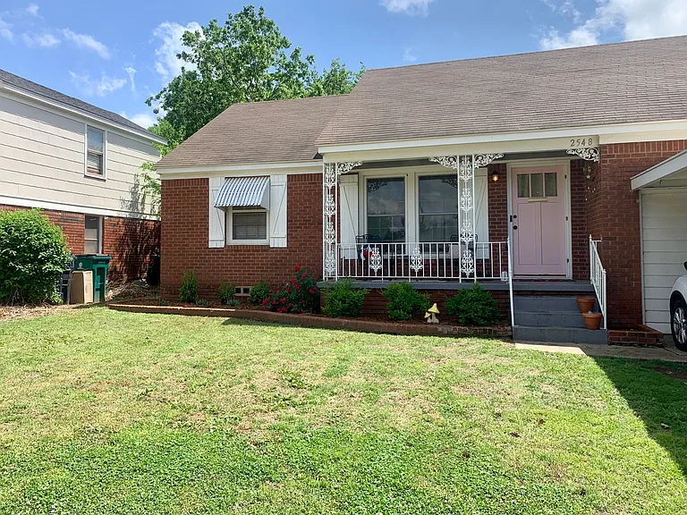 Front of home, portico on right.