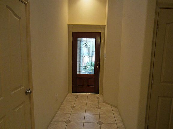 A tiled entrance welcomes you beyond the beautiful mahogany front door.