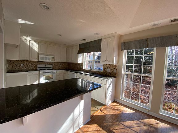 whit kitchen cabinets with granite countertop