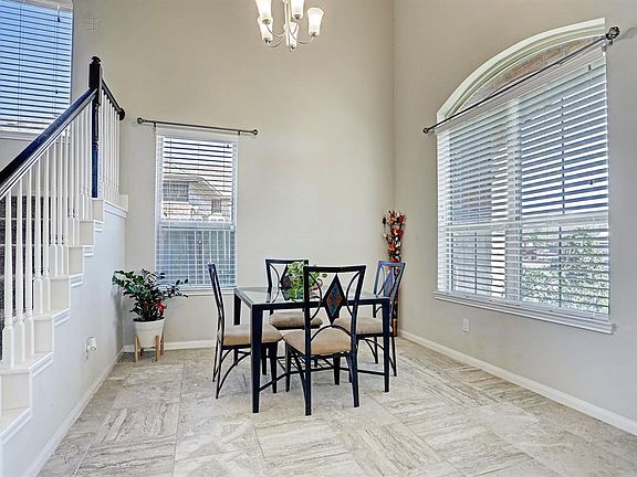 Formal dining room with amazing high ceilings and tons of space.