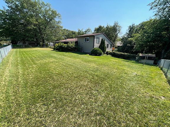 View of the home from the corner of the fenced-in yard.