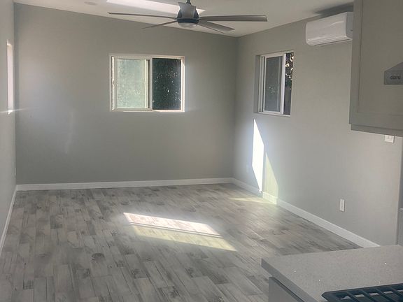 Main living area - new tile floors, dual pane windows, skylights, energy efficient LED lighting, ceiling fan and mini-split AC/heater unit.